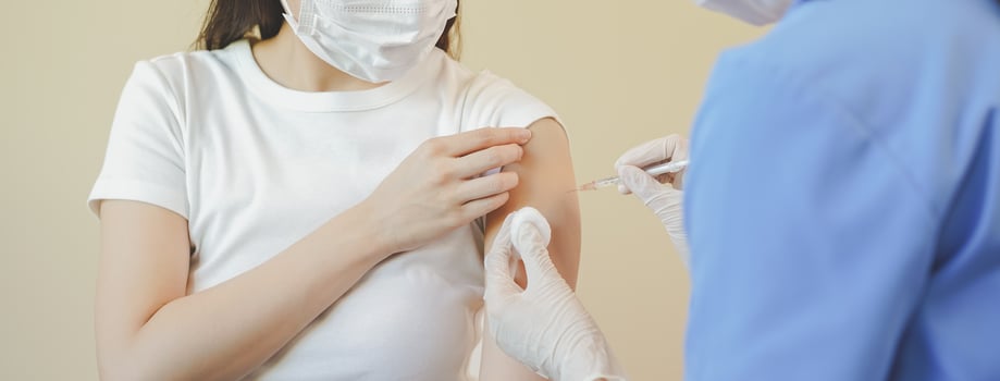 Covid-19,coronavirus hand of young woman nurse,doctor giving syringe vaccine, inject shot to asian arm's patient. Vaccination, immunization or disease prevention against flu or virus pandemic concept. photo