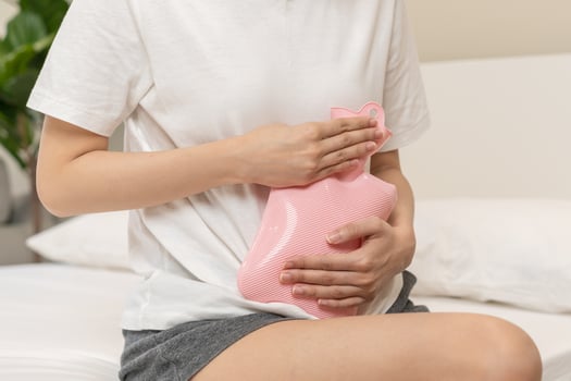Menstruation, period cycle of monthly, hurt asian young woman, female hand in stomachache, suffer from premenstrual, belly or abdomen pain, using hot water bottle. Health problem Inflammation in body. photo