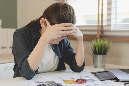 Financial owe asian woman sitting cover face with hands, stressed by calculate expense from invoice or bill, have no money to pay, mortgage or loan. Debt, bankruptcy or bankrupt concept. photo