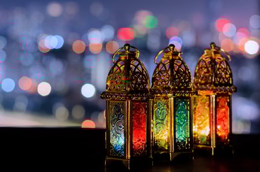Lanterns with night sky and city bokeh light background for the Muslim feast of the holy month of Ramadan Kareem. photo