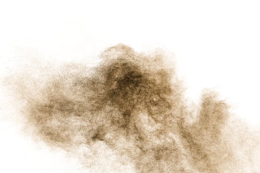 Brown particles splash on white background. Brown dust splatter. photo
