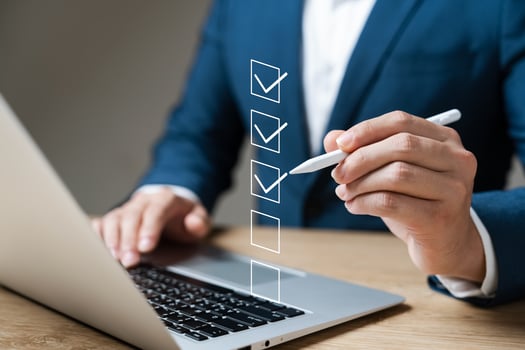 Business performance checklist concept, businessman using laptop doing online checklist survey, filling out digital form checklist. photo