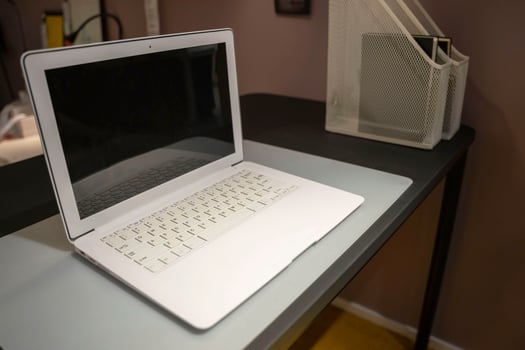 an open laptop with a blank screen on a desk in the office or at home photo