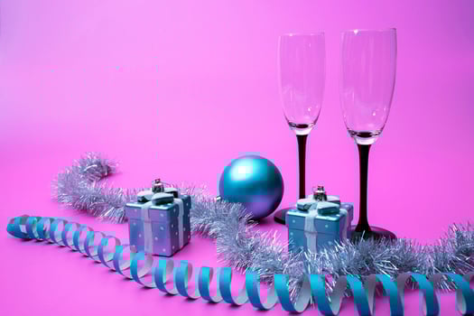 Champagne glasses, New Year's gifts and tinsel and Christmas decorations photo