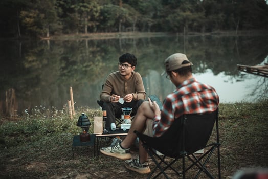 young two-man enjoying coffee drip on the camping day off photo