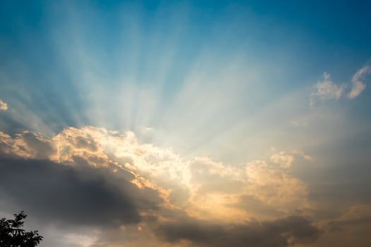 Sunbeam of the sun behind the clouds photo