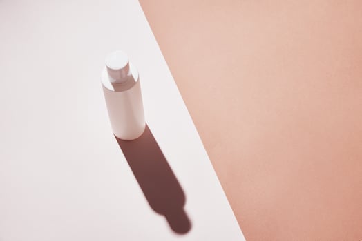 Natural cosmetic product. White bottle on pastel background photo