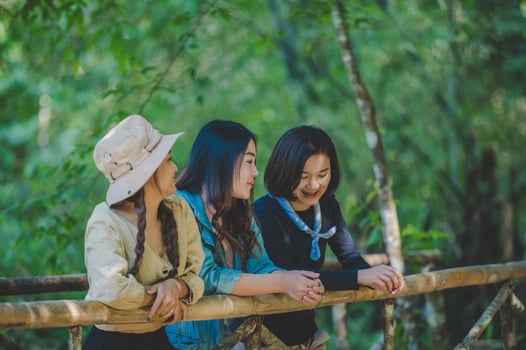 group  young women looking beautiful nature while camping in forest photo