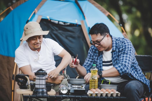Portrait of Asian traveler men cooking at campsite photo
