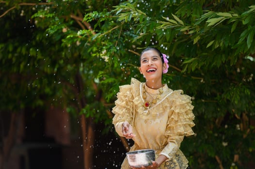Portrait beautiful woman in Songkran festival with Thai Traditional costume photo