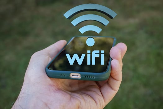 hand holding a smart phone with wifi icon, Wireless Fidelity photo