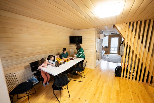 Mother with four children eat fruits in wooden country house on weekend. photo