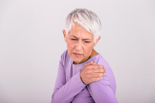 Senior woman with shoulder pain. Elderly woman is enduring awful ache. Shoulder Pain In An Elderly Person. Senior lady with shoulder pain photo