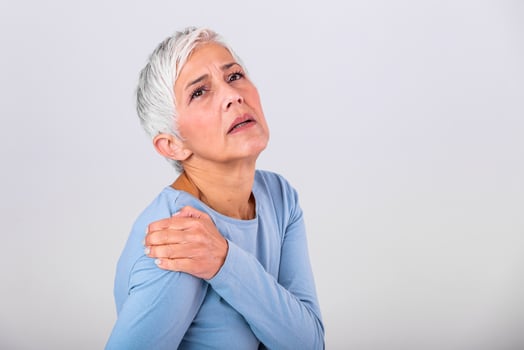 Senior woman with shoulder pain. Elderly woman is enduring awful ache. Shoulder Pain In An Elderly Person. Senior lady with shoulder pain photo