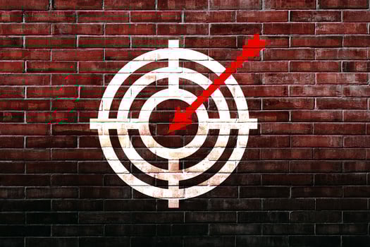 Target figure on brick wall, concept of achieving goal quality, Aim Target Red Symbols of goals and objectives over brick wall background. Business idea photo