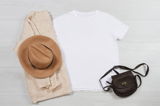 T-shirt mockup. Template blank shirt top view on white wooden background. Winter sweater autumn outfit on wood floor. Woman fashion clothes. Spring look of today. Female accessories photo
