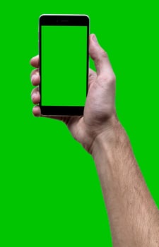 Male hand holding black cellphone with green croma screen at isolated Green background. photo
