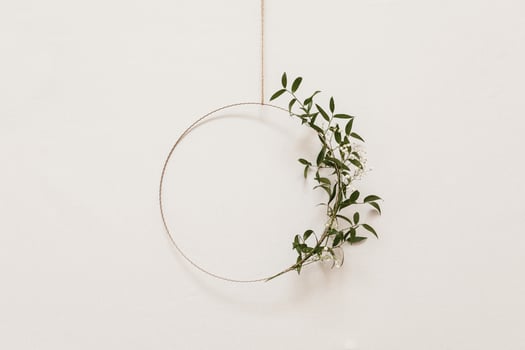 floral and metal construction on white wall background photo
