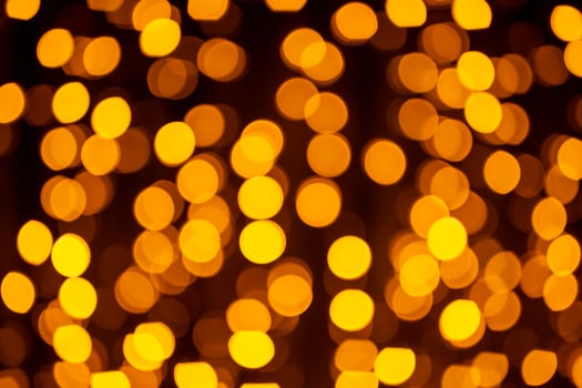 Abstract circular bokeh background of Christmaslight. bokeh from garlands. background for screensaver. Defocused lights. Blurred bokeh with yellow color lights. photo