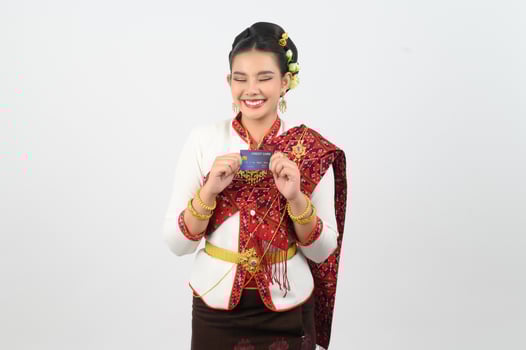 Portrait of Beautiful Thai Woman in Traditional Clothing Posing with credit card photo