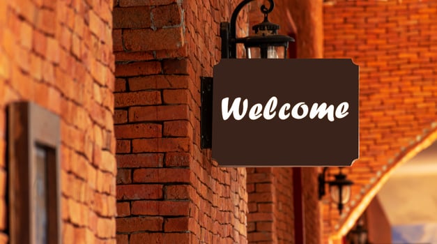 Outdoor brown sign with message Welcome photo