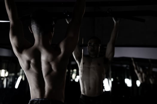 Sexy body of muscular young soldier Asian man in gym. Concept of health care, exercise fitness, Strong muscle mass, body enhancement, fat reduction for men's health supplement product presentation. photo