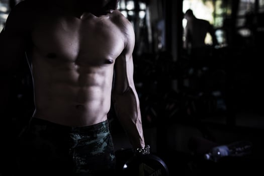 Sexy body of muscular young soldier Asian man in gym. Concept of health care, exercise fitness, Strong muscle mass, body enhancement, fat reduction for men's health supplement product presentation. photo