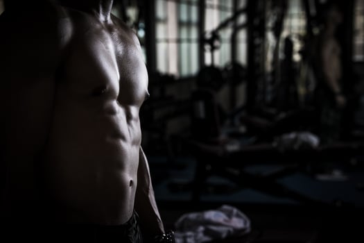 Sexy body of muscular young soldier Asian man in gym. Concept of health care, exercise fitness, Strong muscle mass, body enhancement, fat reduction for men's health supplement product presentation. photo