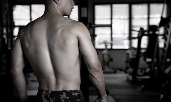 Sexy body of muscular young soldier Asian man in gym. Concept of health care, exercise fitness, Strong muscle mass, body enhancement, fat reduction for men's health supplement product presentation. photo