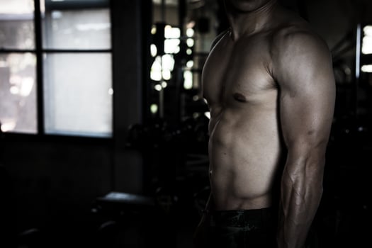 Sexy body of muscular young soldier Asian man in gym. Concept of health care, exercise fitness, Strong muscle mass, body enhancement, fat reduction for men's health supplement product presentation. photo