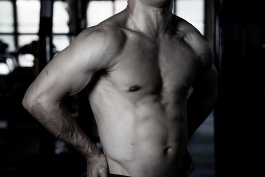 Sexy body of muscular young soldier Asian man in gym. Concept of health care, exercise fitness, Strong muscle mass, body enhancement, fat reduction for men's health supplement product presentation. photo