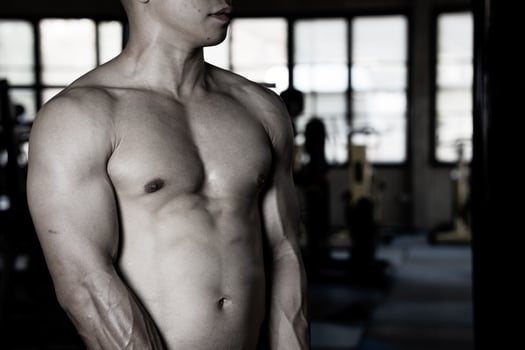 Sexy body of muscular young soldier Asian man in gym. Concept of health care, exercise fitness, Strong muscle mass, body enhancement, fat reduction for men's health supplement product presentation. photo