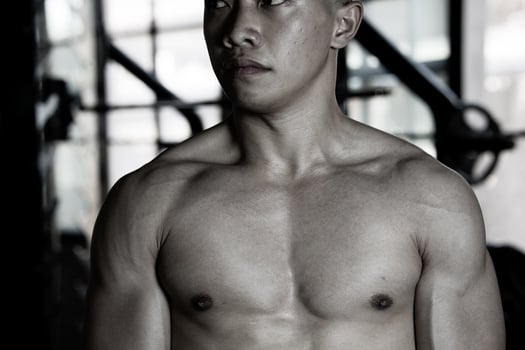 Sexy body of muscular young soldier Asian man in gym. Concept of health care, exercise fitness, Strong muscle mass, body enhancement, fat reduction for men's health supplement product presentation. photo