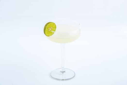 Classic margarita cocktail with salt and lime on the white background. photo