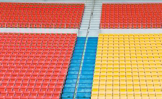 Empty orange and yellow seats at stadium,Rows of seat on a soccer stadium photo