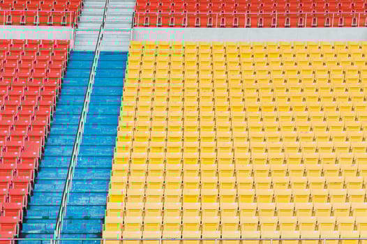 Empty orange and yellow seats at stadium,Rows of seat on a soccer stadium photo