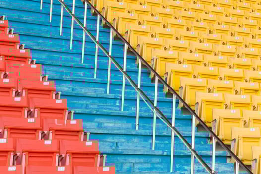 Empty orange and yellow seats at stadium,Rows of seat on a soccer stadium photo