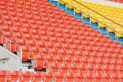 Empty orange and yellow seats at stadium,Rows of seat on a soccer stadium photo