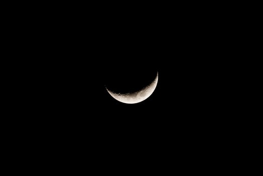 Dark night sky with shining crescent moon photo