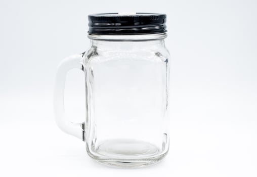 Glass bottle with black cap on isolated white background. An object with isolated background. photo