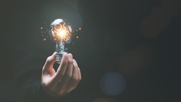 solution concept and demonstrating leadership strategies ,ideas ,thought process ,innovation and brain power from brainstorming ,A light bulb representing the power of thought in the human hand photo