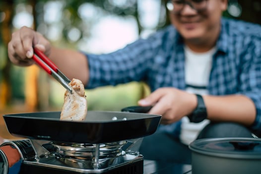 Portrait of Asian traveler man glasses pork steak frying photo