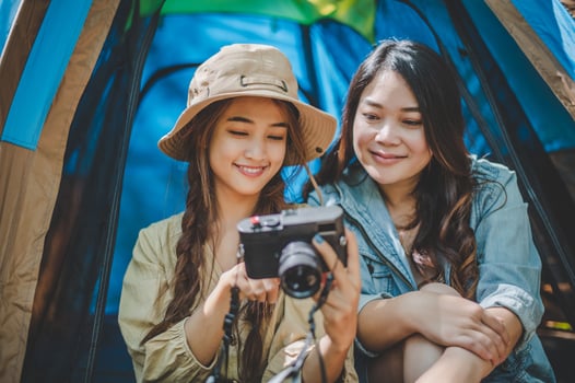 Young woman use camera taking photo and show her friends