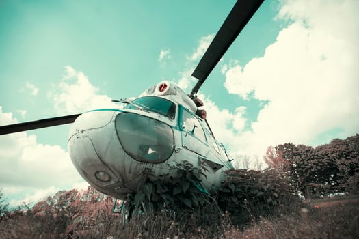 Vintage retro helicopter on the background of the emerald sky. photo