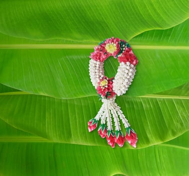 Handmade jasmine garland, a symbol of Mother's Day in Thailand. on banana leaf background photo