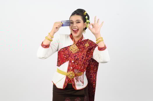 Young beautiful woman in northeastern dress show credit card posture photo