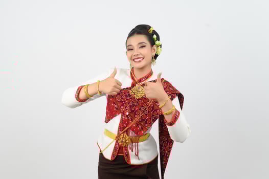 Young beautiful woman in Thai lanna costume with thumb up posture photo