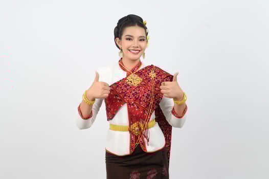 Young beautiful woman in northeastern dress stand and thumb up posture photo