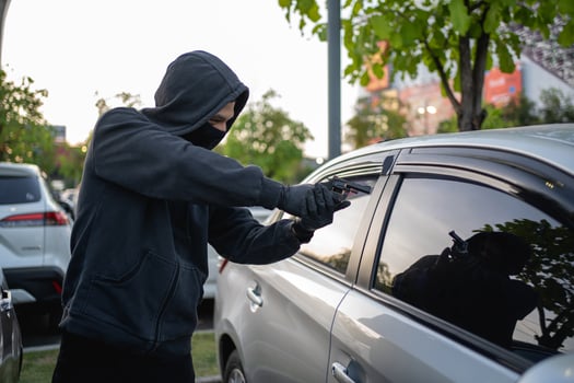 Terrorist or car thief pointing gun at driver photo