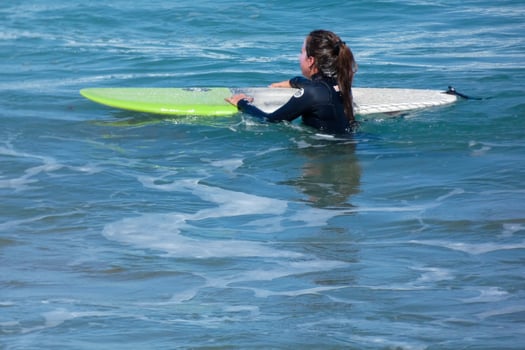 young athletes practising the water sport of surfing photo